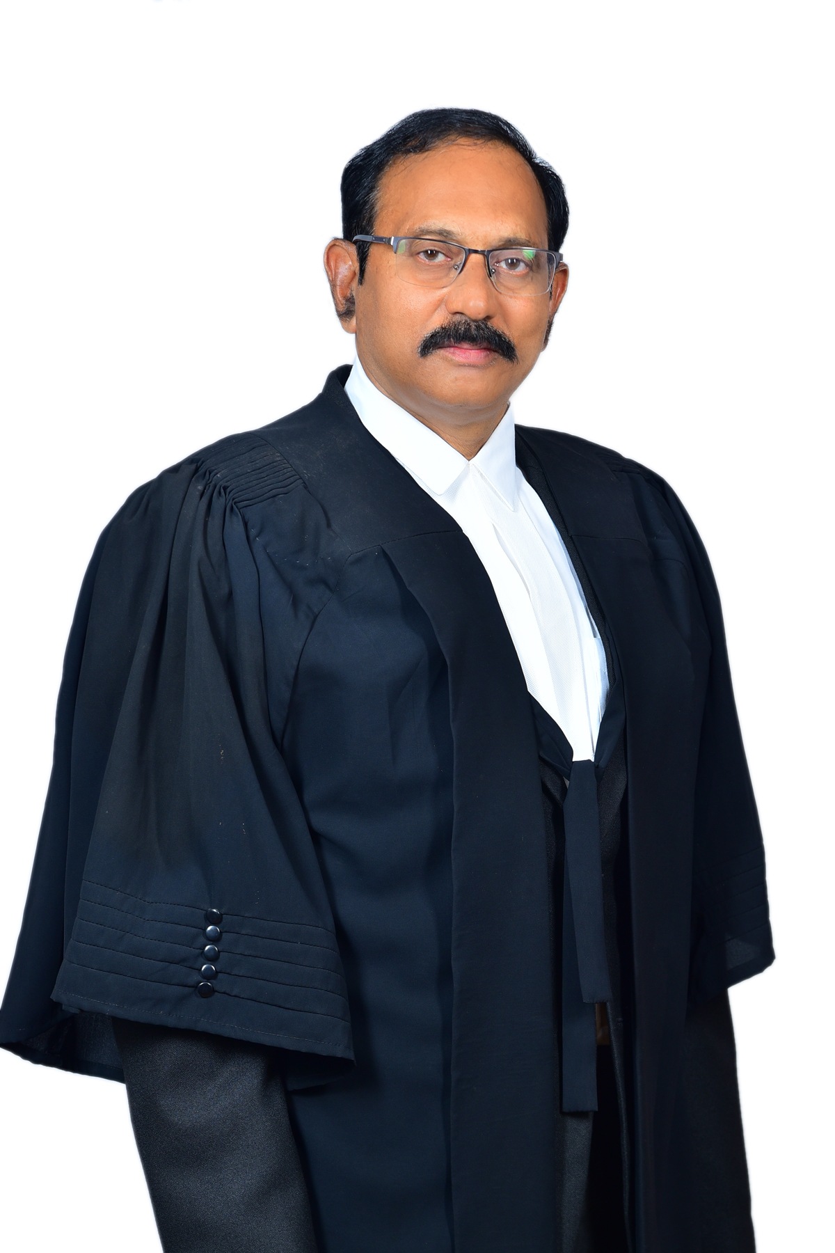A man in a black judicial robe and glasses, with a mustache, looks forward.