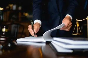 An image depicting hands holding or signing legal documents.
